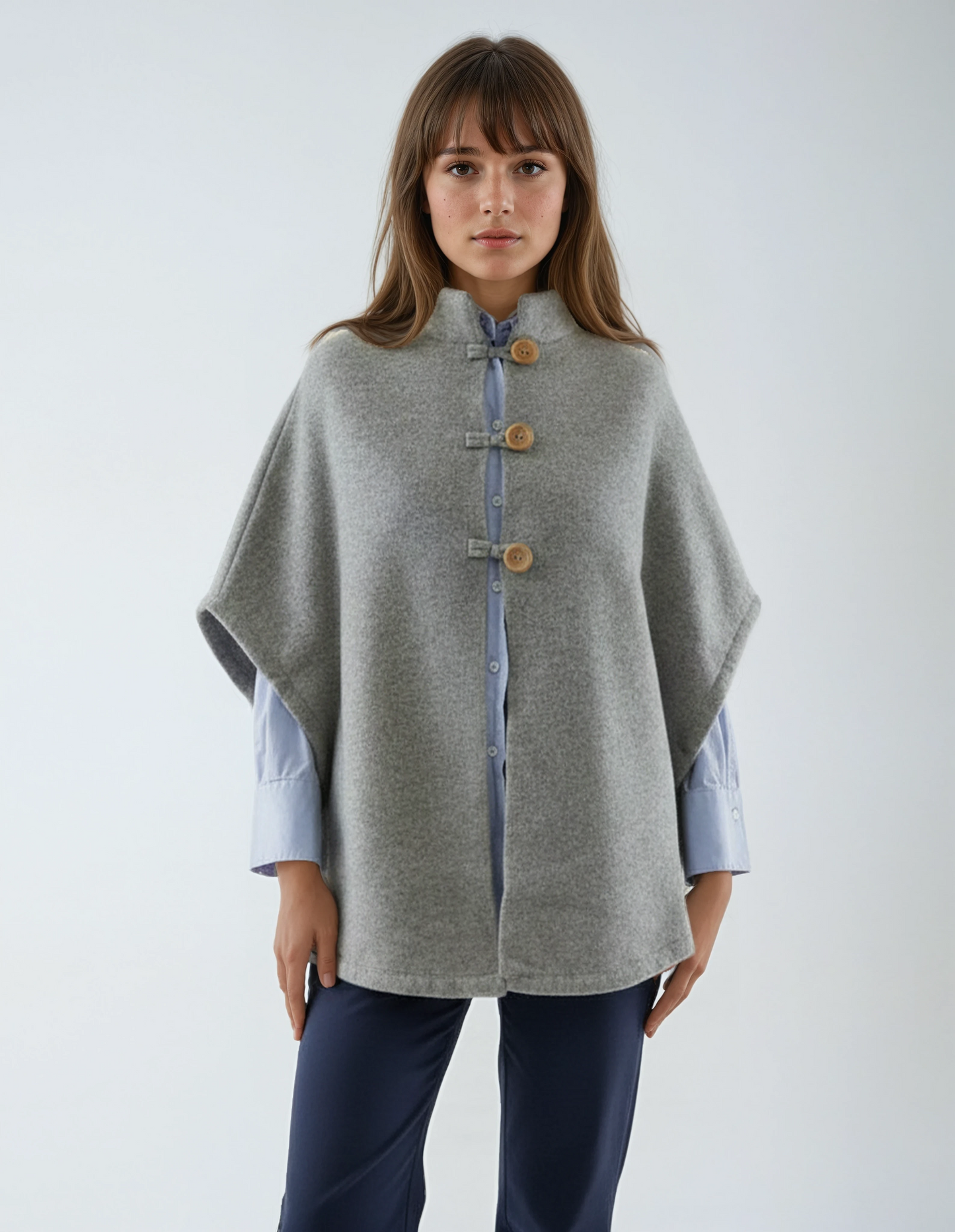 Warm wool poncho in light grey. Premium lambswool knit with wooden buttons, made in Portugal