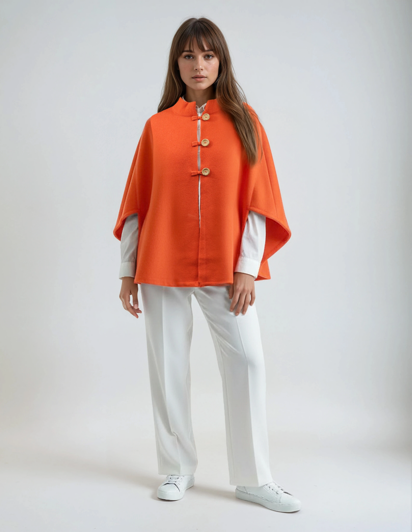 Orange wool poncho. High-quality, soft lambswool for women, featuring a wooden button detail