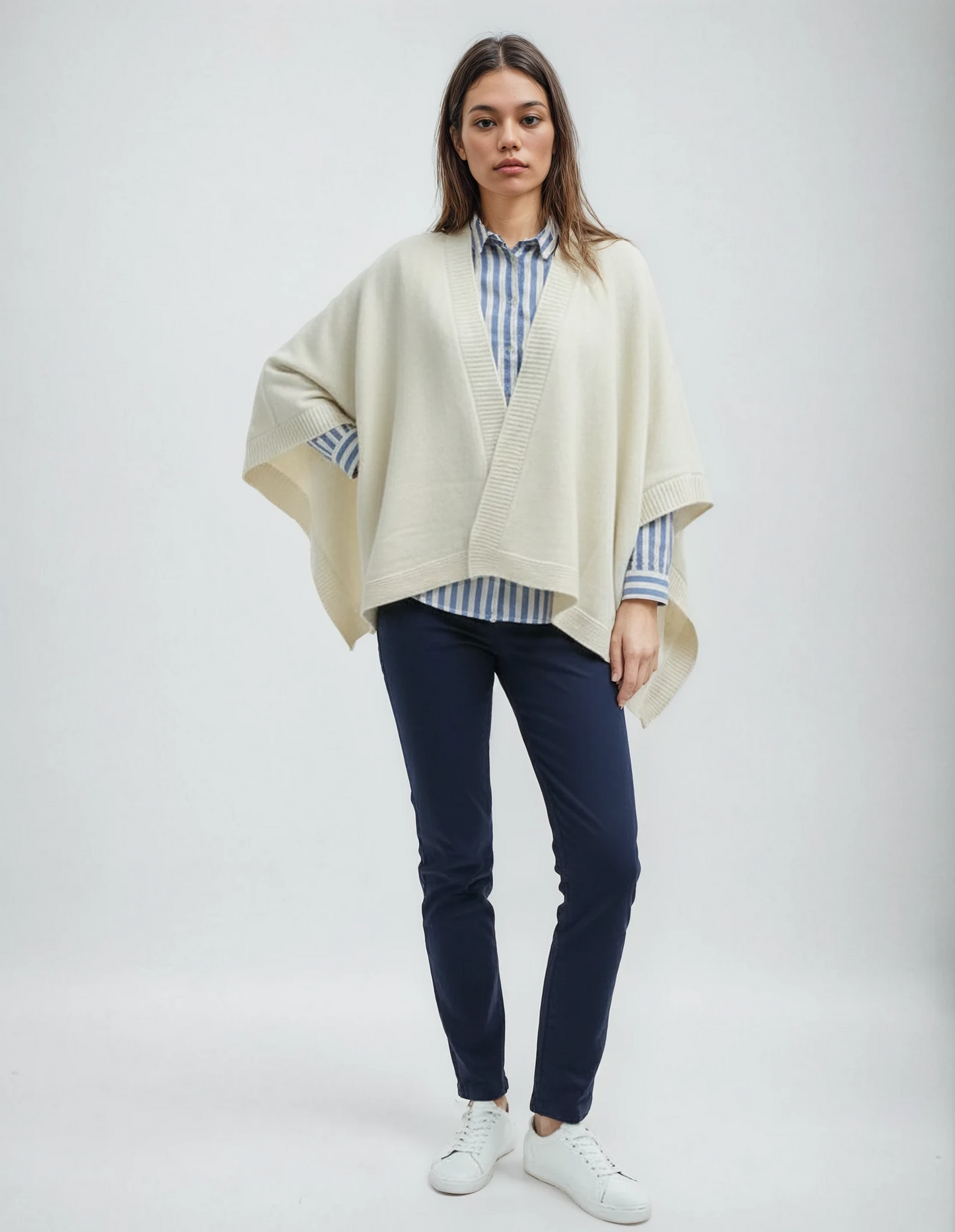 Pearl wool cape layered over a striped shirt