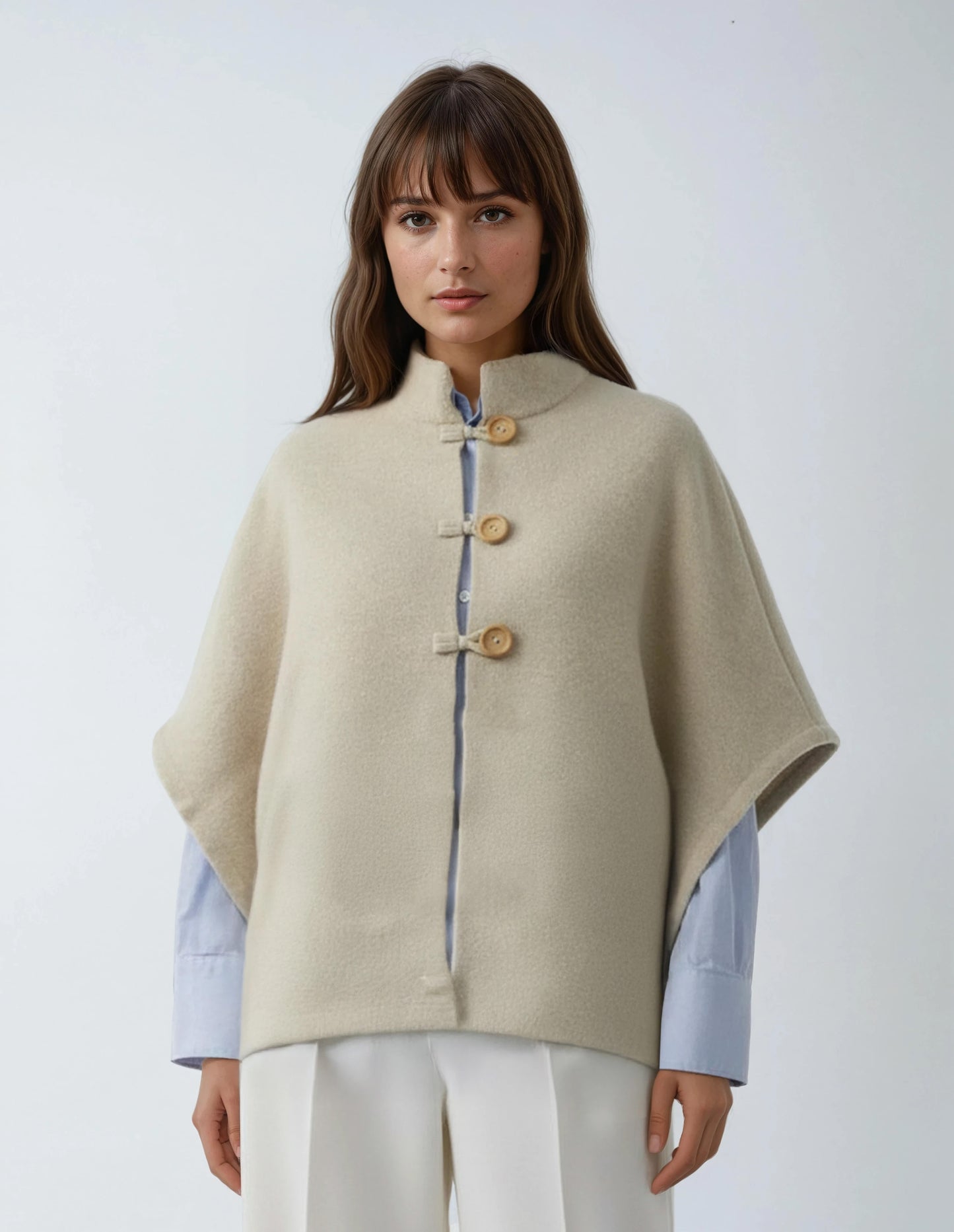 Sand wool poncho. High-quality, soft lambswool for women, featuring a wooden button detail