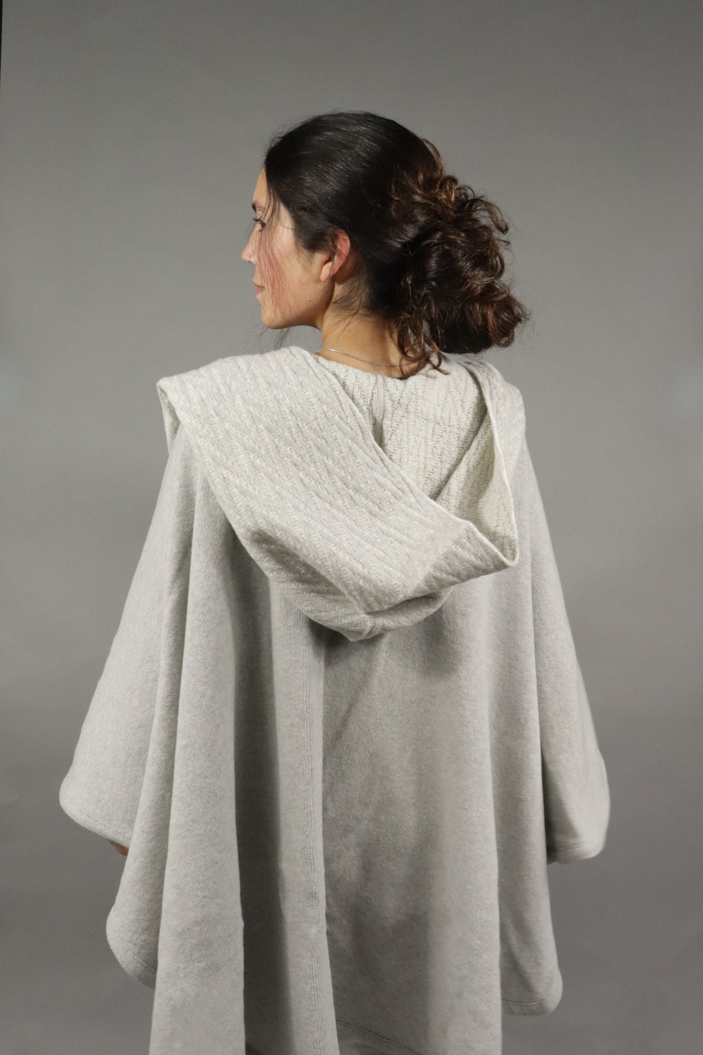 Back view of the light greu lambswool cape showcasing the herringbone pattern