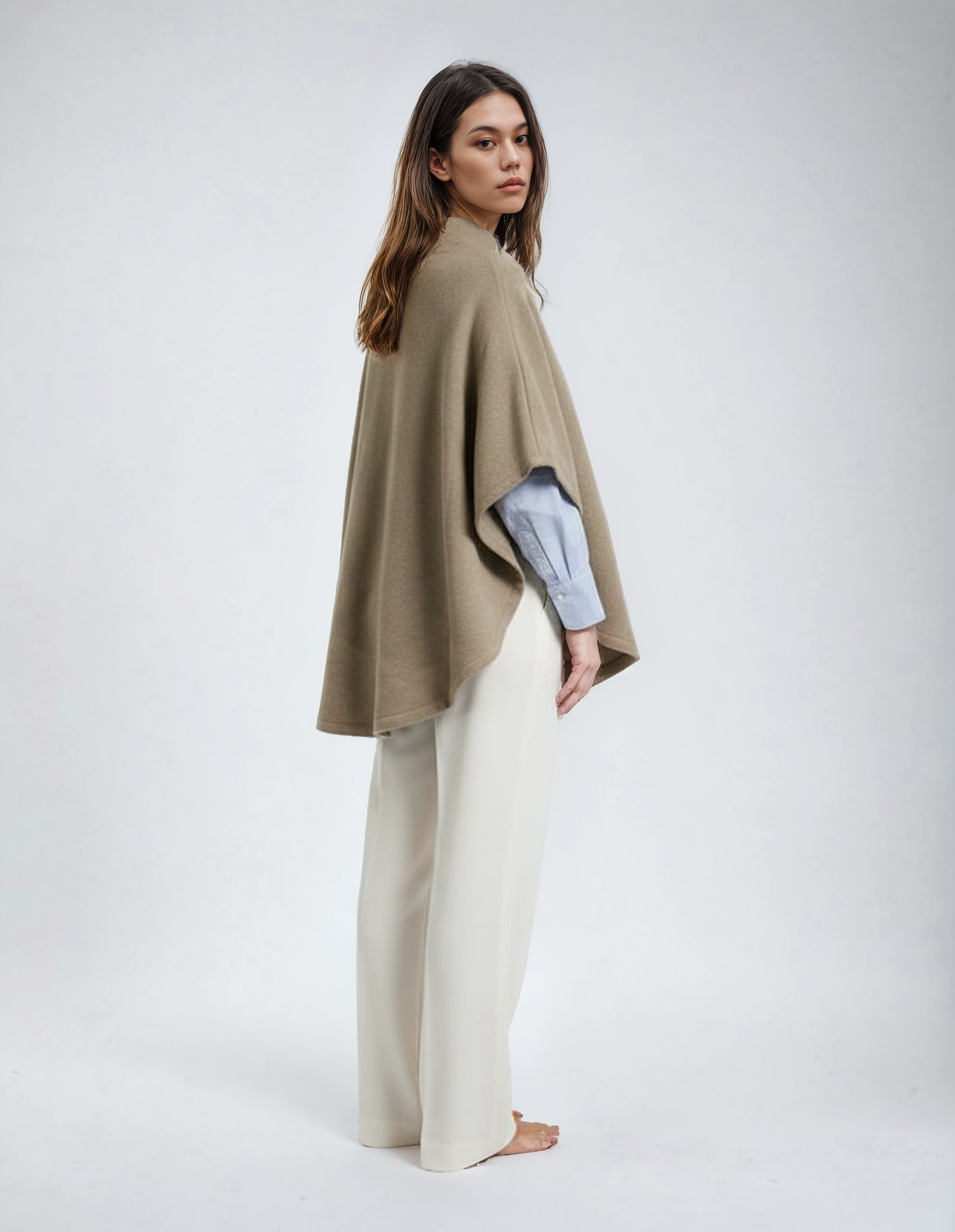 Classic wool poncho in bege color. Lightweight lambswool jacket with natural wooden buttons for women