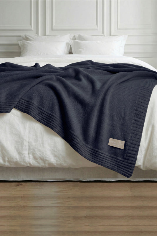 Tecmalha navy blue lambswool blanket featuring a plain knit pattern and a ribbed border. Made in Portugal